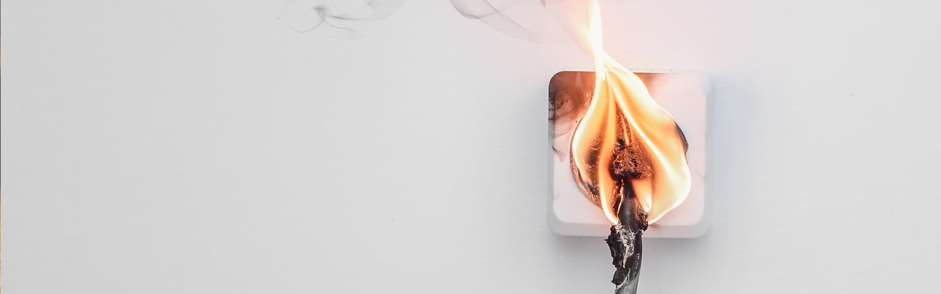 A wall outlet sparking and burning