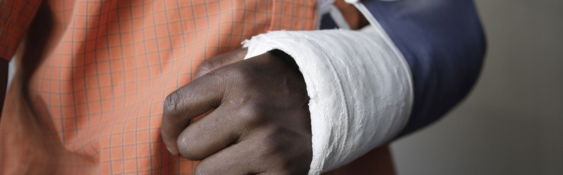 A person with an arm in a cast and sling